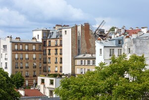 A row of multi-story buildings with varied architectural styles, including brick facades and large windows.