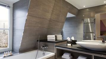 Une salle de bain moderne avec une grande baignoire, un meuble-lavabo et un miroir.