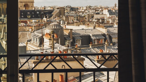 A cityscape with a prominent tower and dense urban architecture. - Hôtel Madison (Paris)