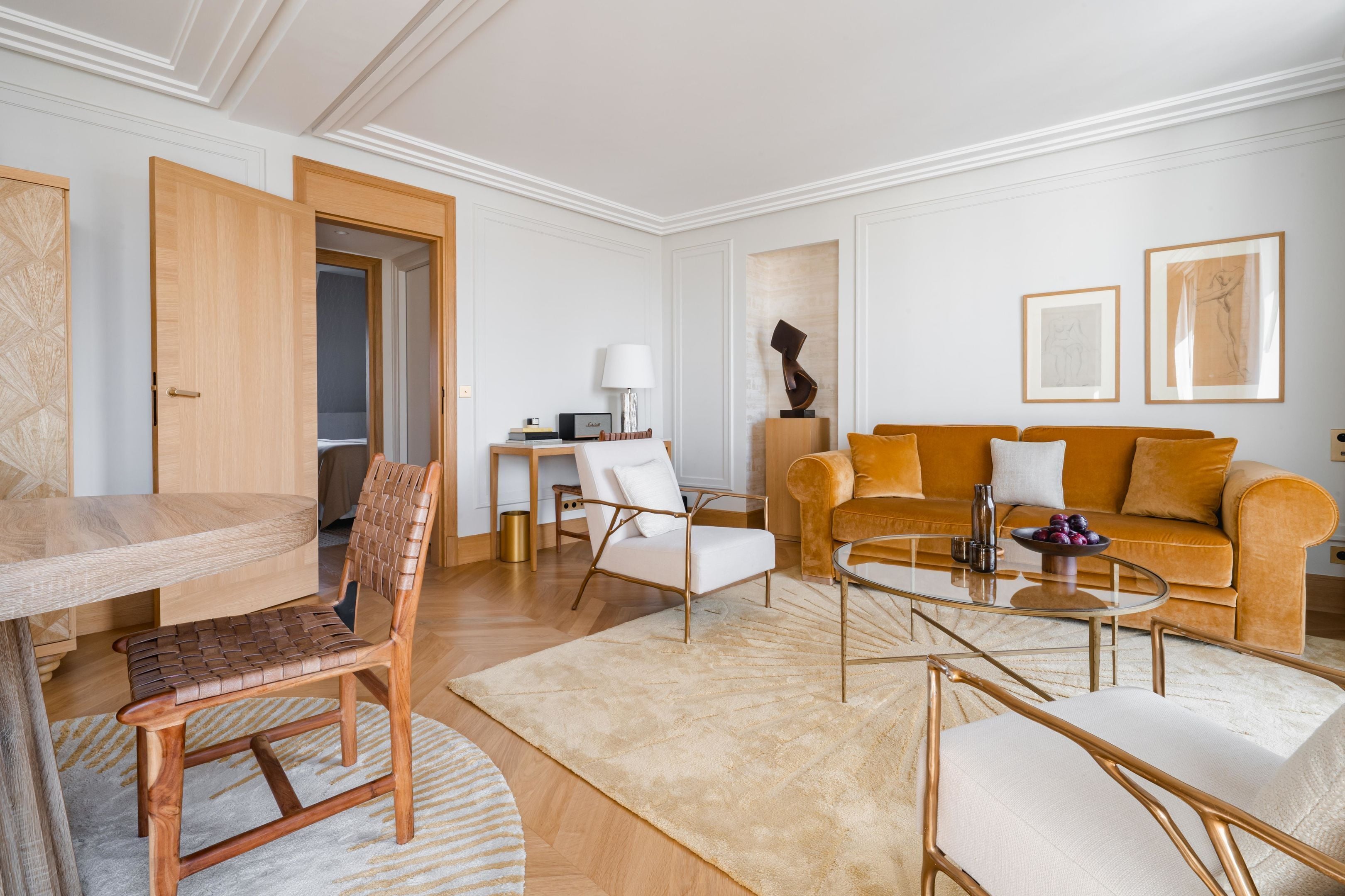 A modern living room with a wooden dining table, a sofa, and a coffee table.