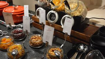 A buffet with various food items in glass containers, each labeled with a name and number.