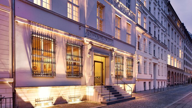 A historic building with ornate ironwork, a grand entrance, and a cobblestone street. - art'otel Berlin Mitte (Berlin)