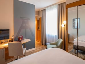Premium bedding, desk, laptop workspace, blackout curtains