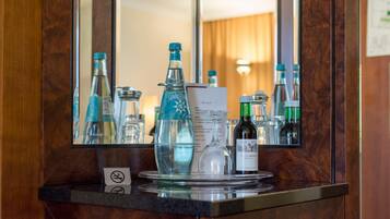 A bar area with a mirror reflecting bottles and glasses, a menu, and a no-smoking sign.