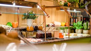 A buffet setup with various food items and condiments. - Sporthotel Grafenwald (Daun)