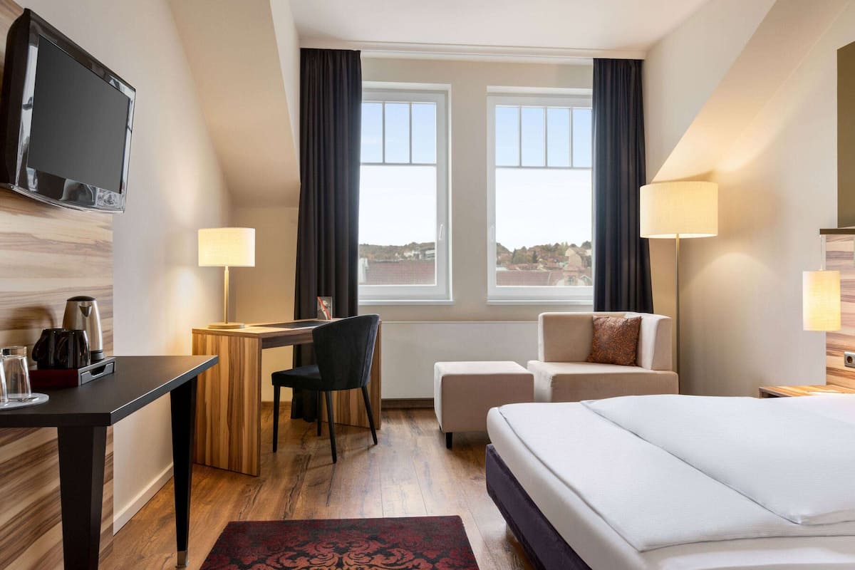 deluxe single room | in-room safe, desk, laptop workspace, blackout curtains