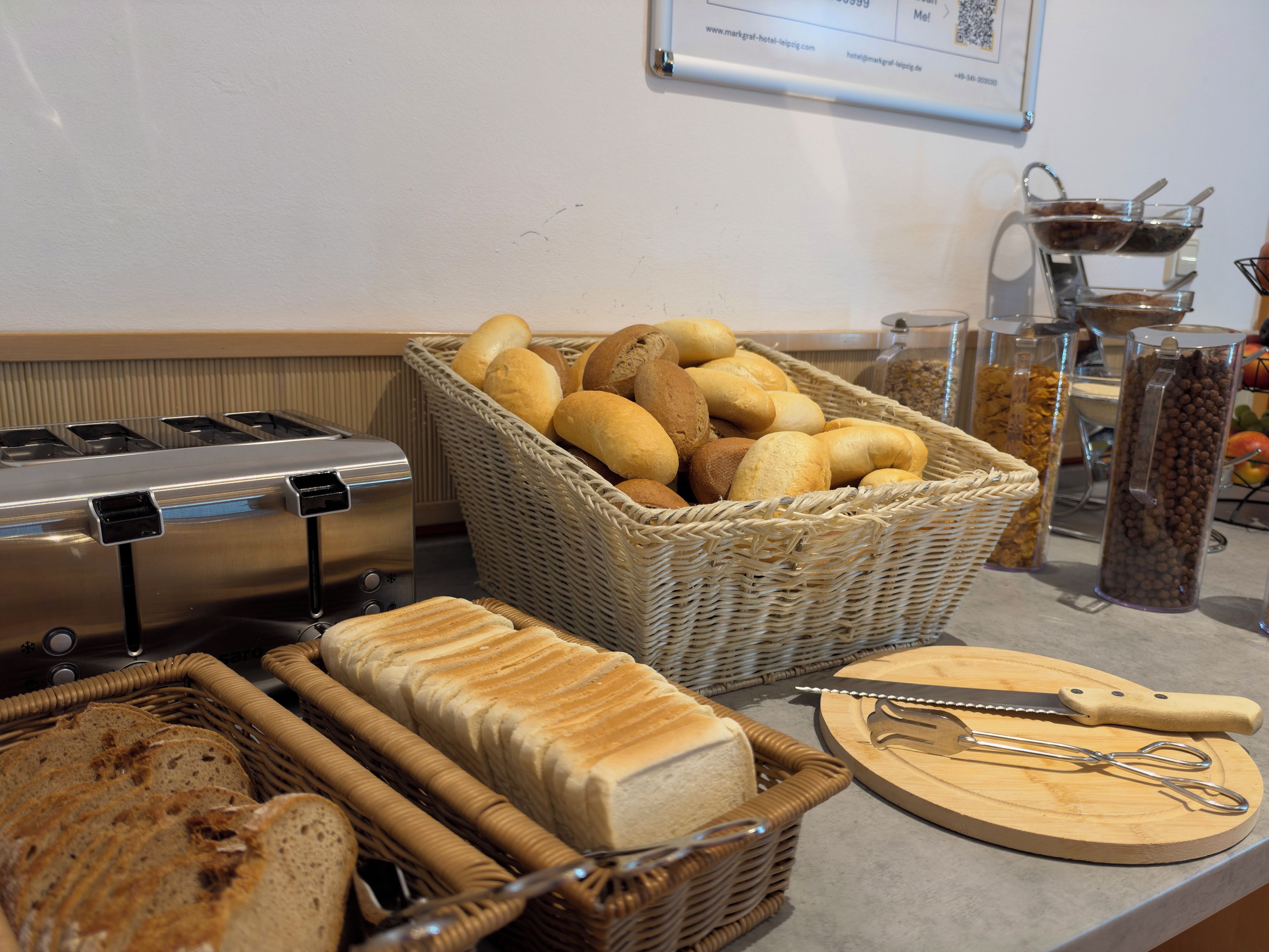 A buffet area with various breads and a coffee machine.