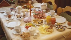 A dining table set with plates, cups, and various food items, suggesting a meal setting. - Hotel Jedermann (Munich)
