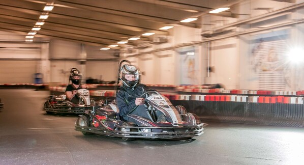 A go-kart track with go-karts and riders.