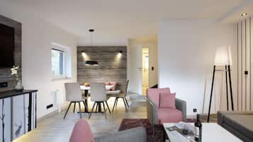 A modern living room with a dining area, a sofa, a coffee table, and a lamp.