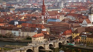 A historic cityscape with a prominent church and a bridge over a river. - Best Western Hotel Wuerzburg Sued (Würzburg)