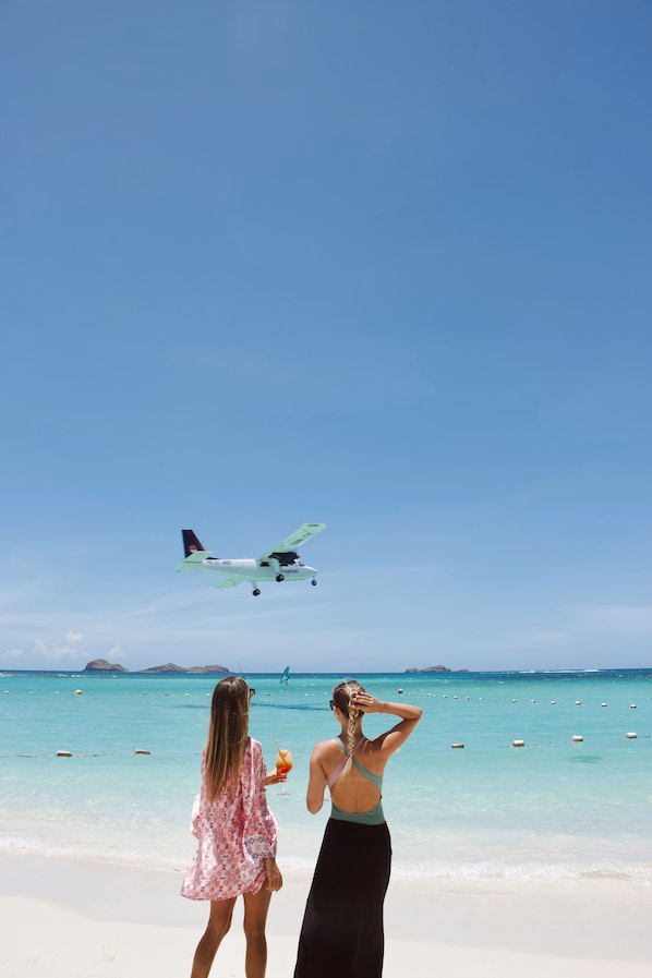 On the beach, white sand, sun loungers, beach umbrellas