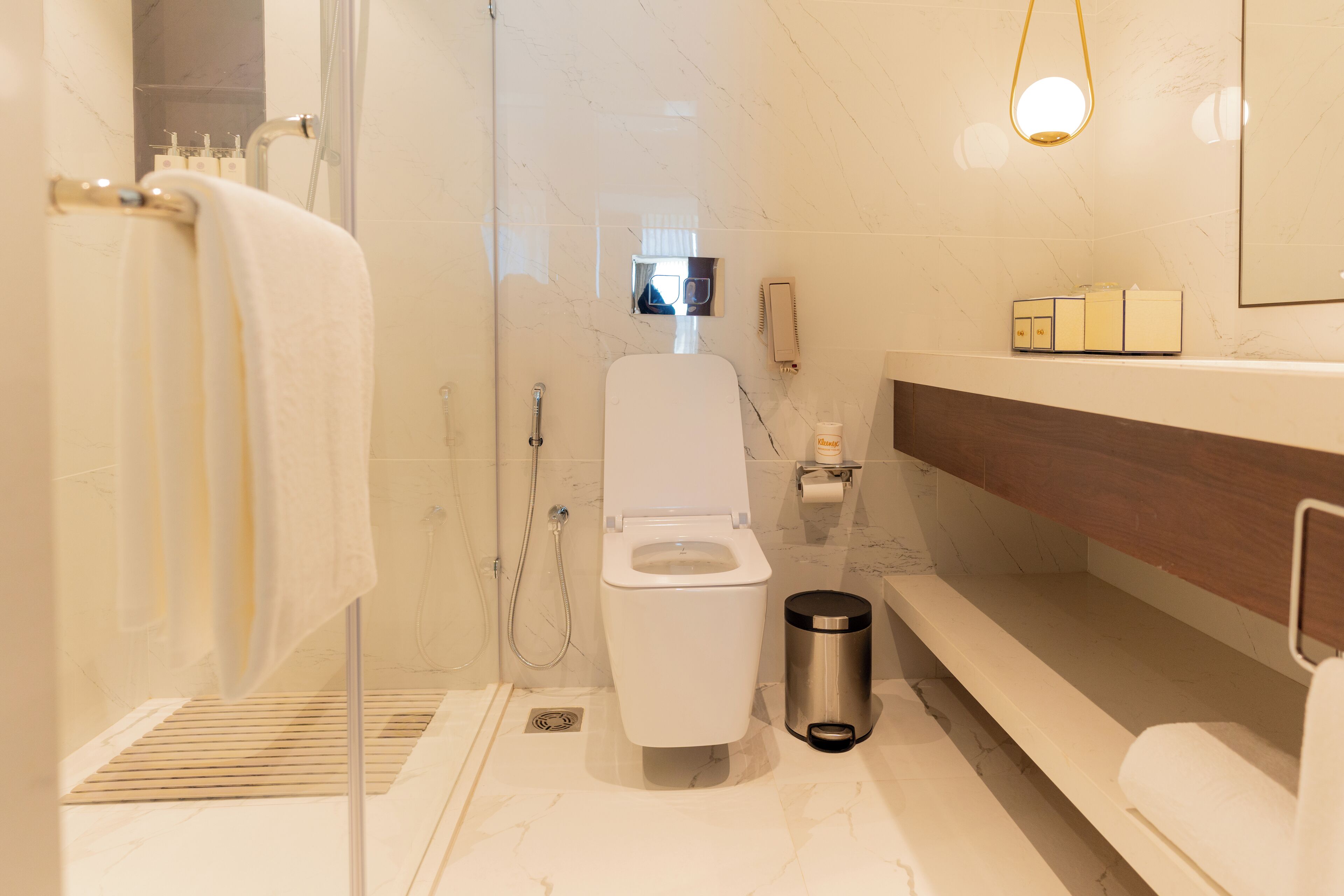 A modern bathroom with a toilet, bidet, and shower.