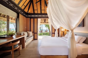 A room with a bed, a desk, and a view of the outdoors. - Novotel Bali Benoa (Nusa Dua)