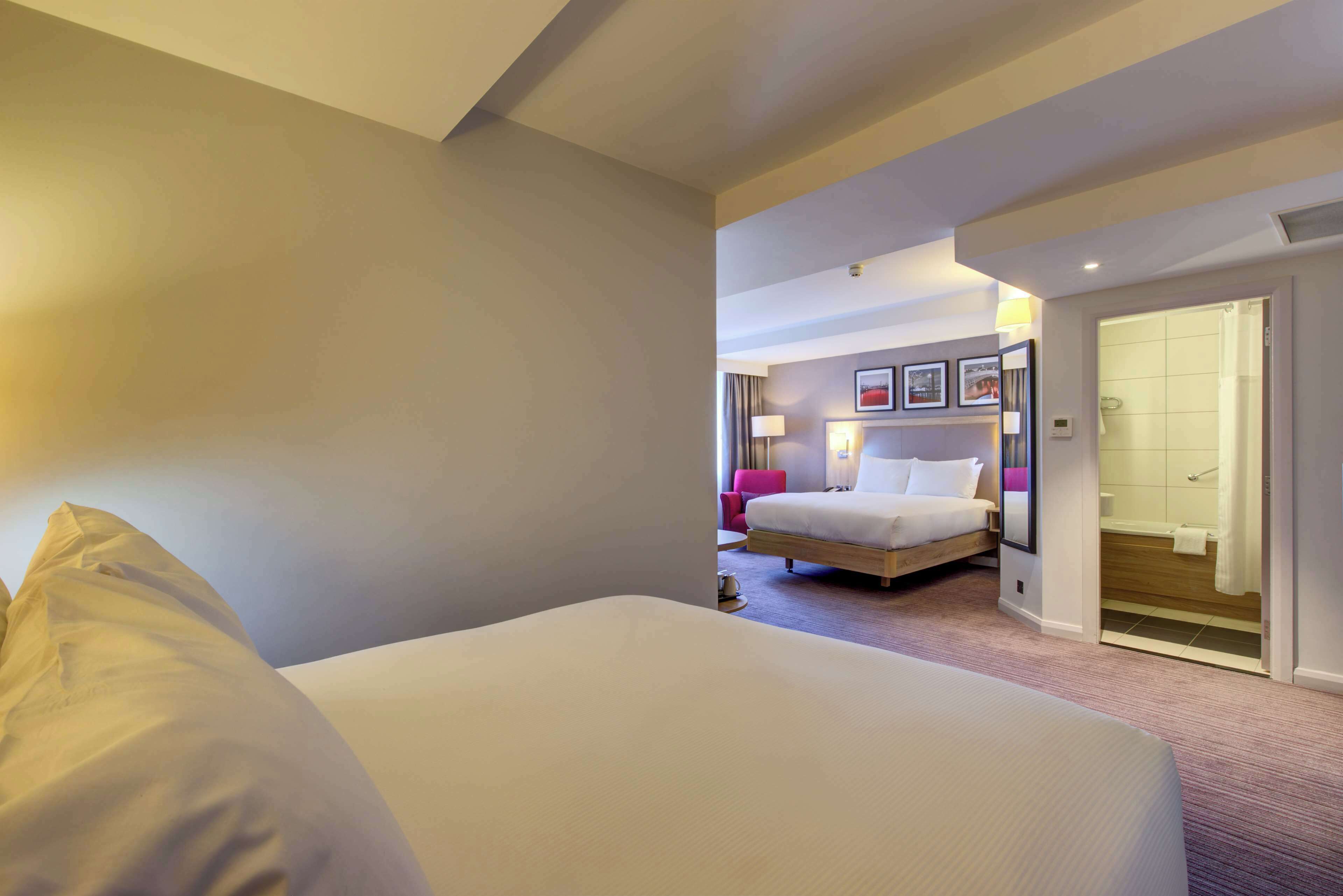 family room, 2 queen beds | premium bedding, in-room safe, desk, laptop workspace