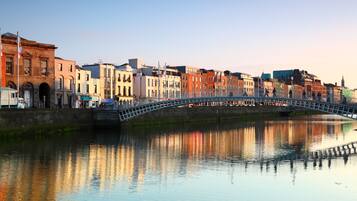 A historic bridge over a calm river with buildings on either side.