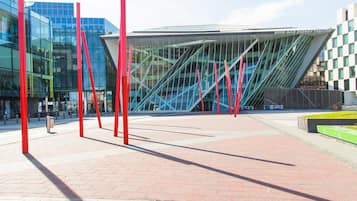A modern building with a glass facade, red structural elements, and a sign indicating it's the Bord Gais Energy Theatre.
