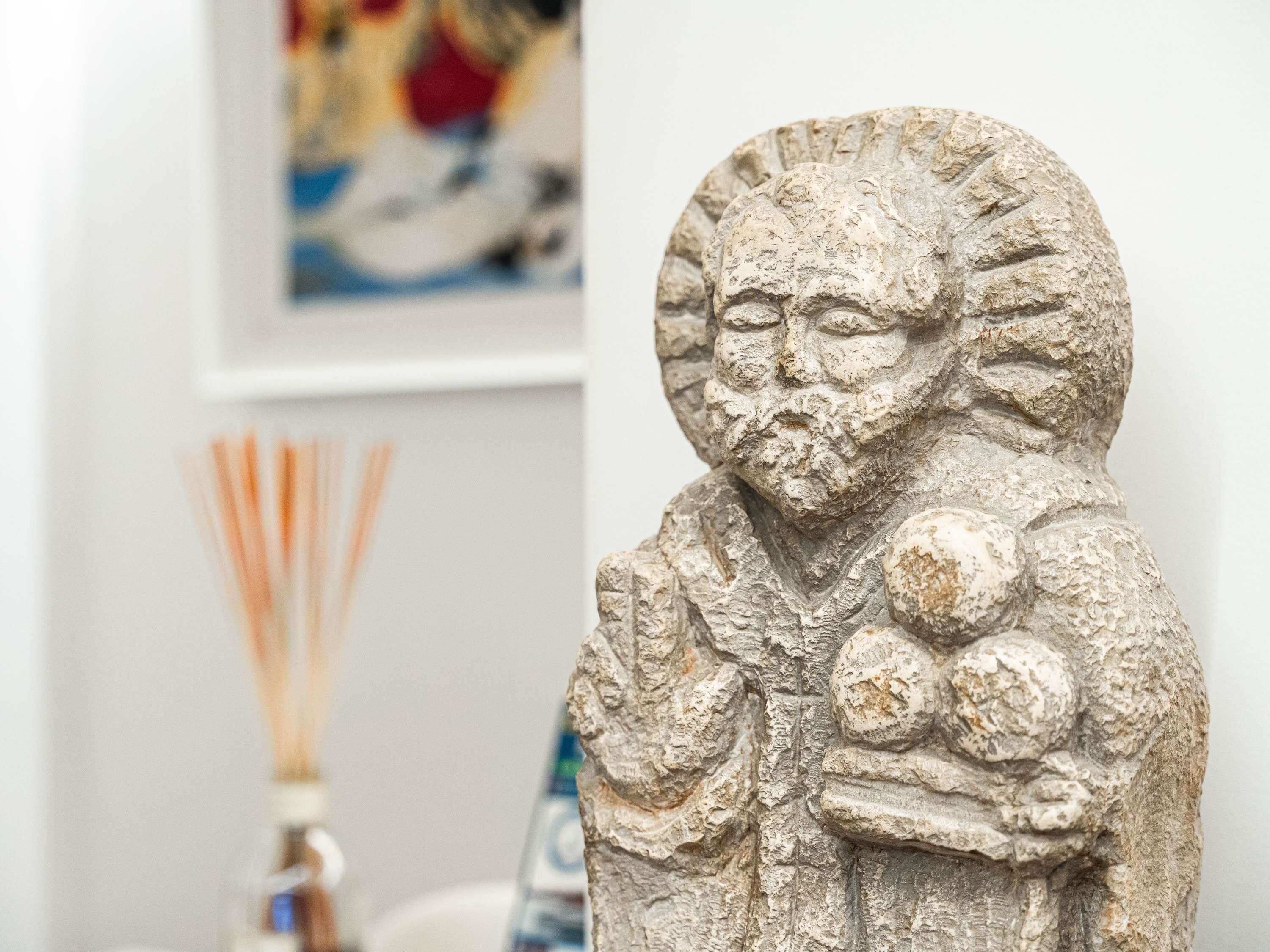 A stone sculpture with a textured surface, possibly a decorative piece.