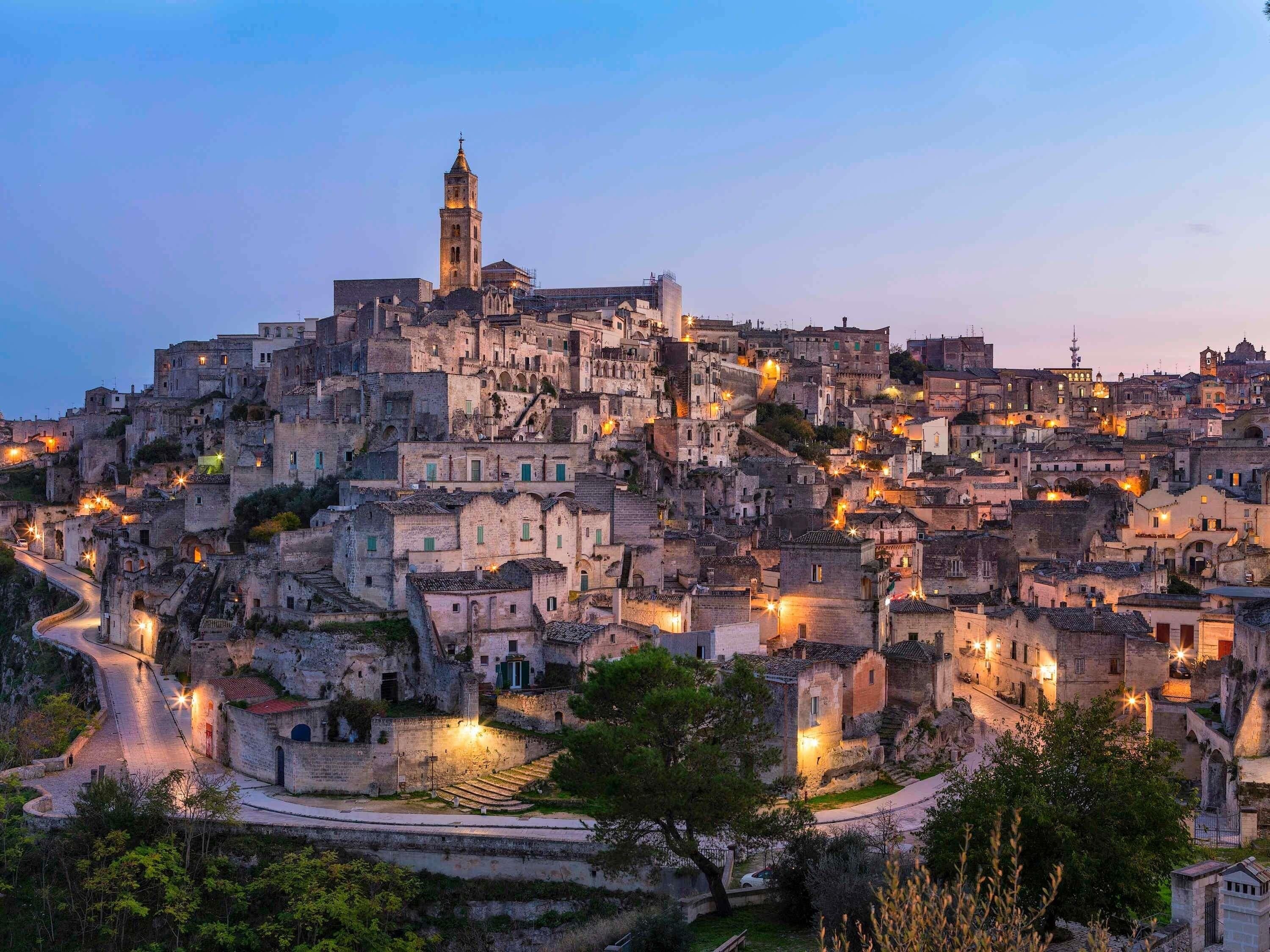 A historic town with a prominent tower, narrow winding streets, and stone buildings.