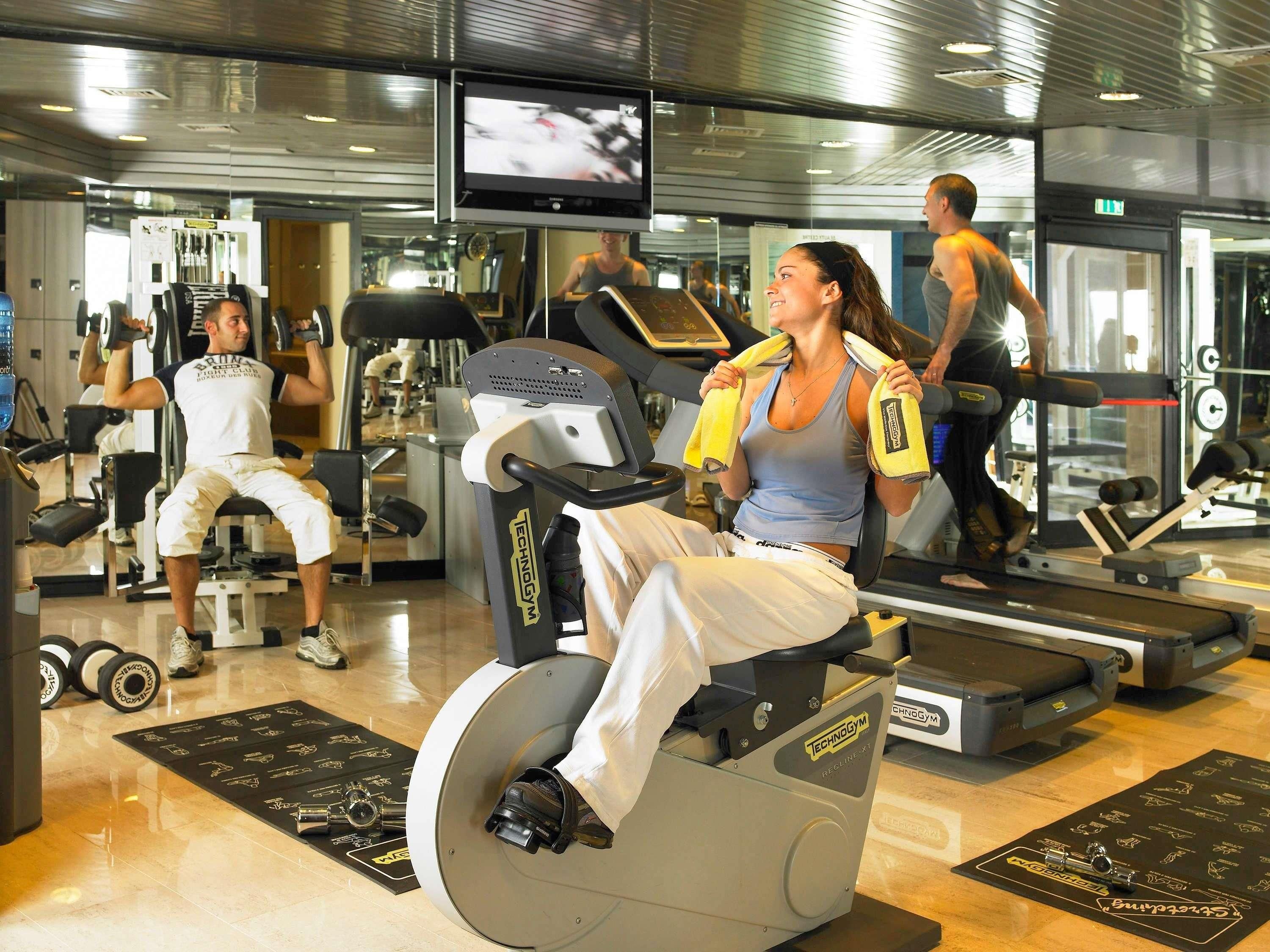 A gym with stationary bikes, treadmills, and weight machines.