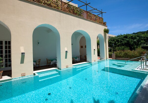 Seasonal outdoor pool, open 10:30 AM to 7:00 PM, pool umbrellas