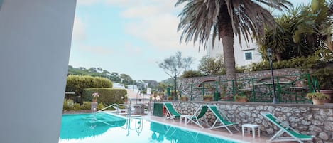 Seasonal outdoor pool, open 10:30 AM to 7:00 PM, pool umbrellas