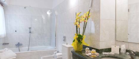A modern bathroom with a bathtub, toilet, and sink.