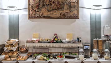 A buffet setup with various food items and a coffee machine.