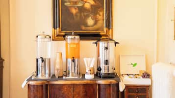 A breakfast bar with coffee dispensers, a punch bowl, and a blender.