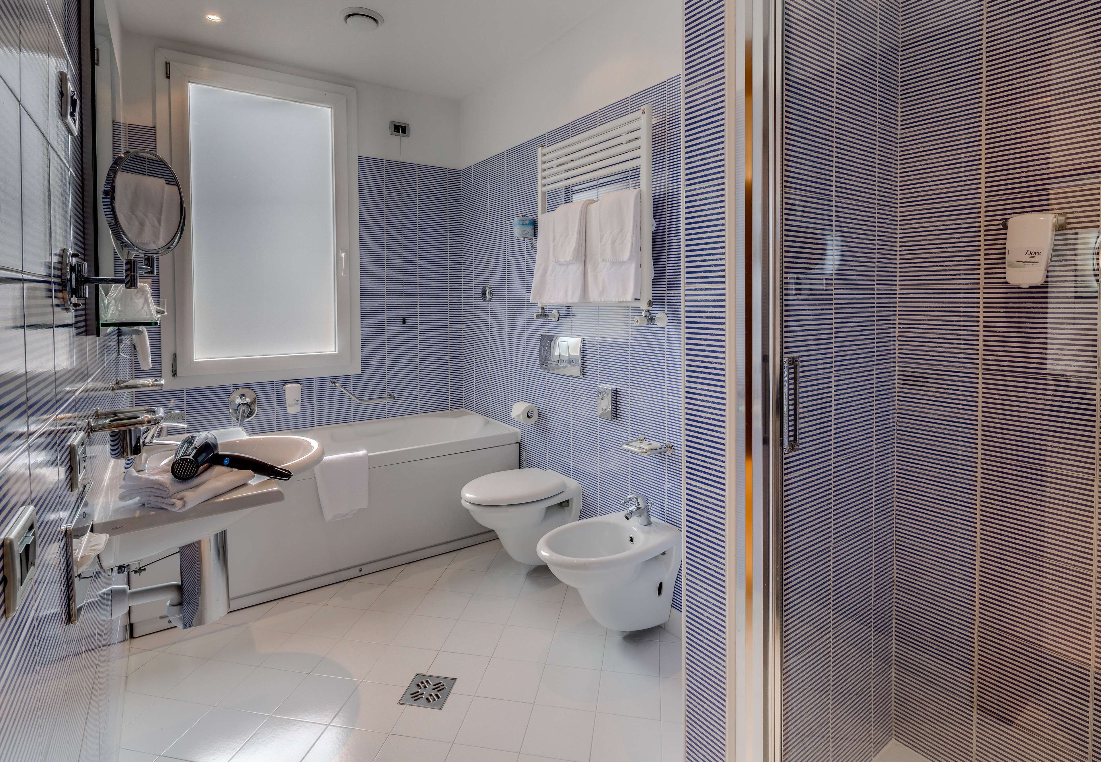 junior suite, 1 king bed | bathroom | free toiletries, hair dryer, slippers, bidet