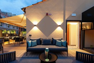An outdoor seating area with a sofa, chairs, and a coffee table.