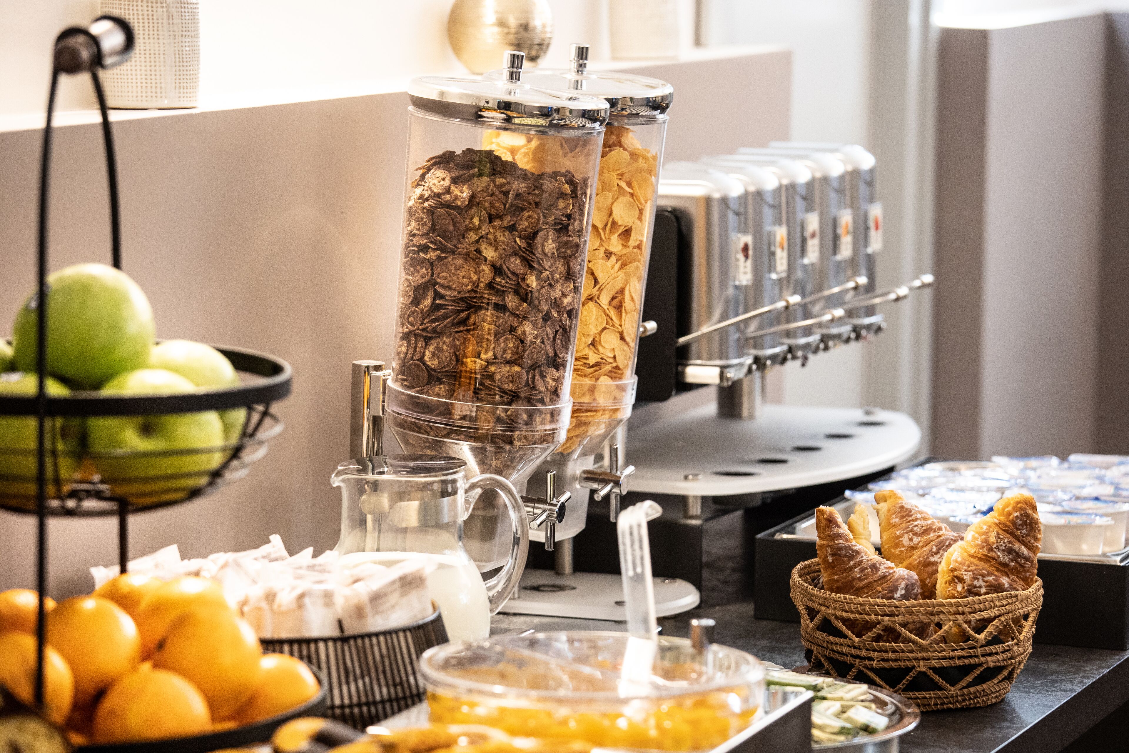 A buffet setup with various food items and a coffee machine.