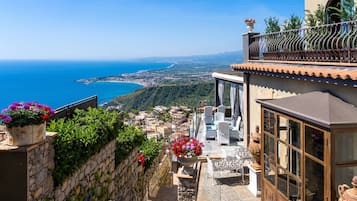 Enjoy breathtaking views of the coastal landscape from the balcony with a scenic view.