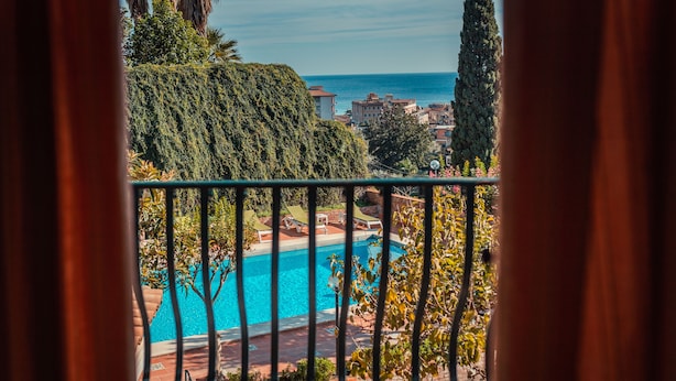 Vista de una piscina bajo un cielo despejado y edificios lejanos.