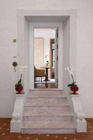 A staircase leading to a dining area with a view of the dining room.
