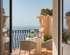 A balcony with a table set for two, overlooking the sea. - San Domenico Palace, Taormina, A Four Seasons Hotel (Taormina)