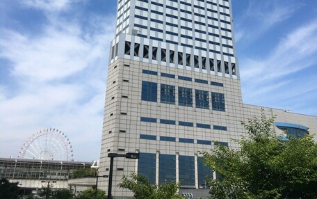 A tall, modern skyscraper with a grid-like facade and large windows.