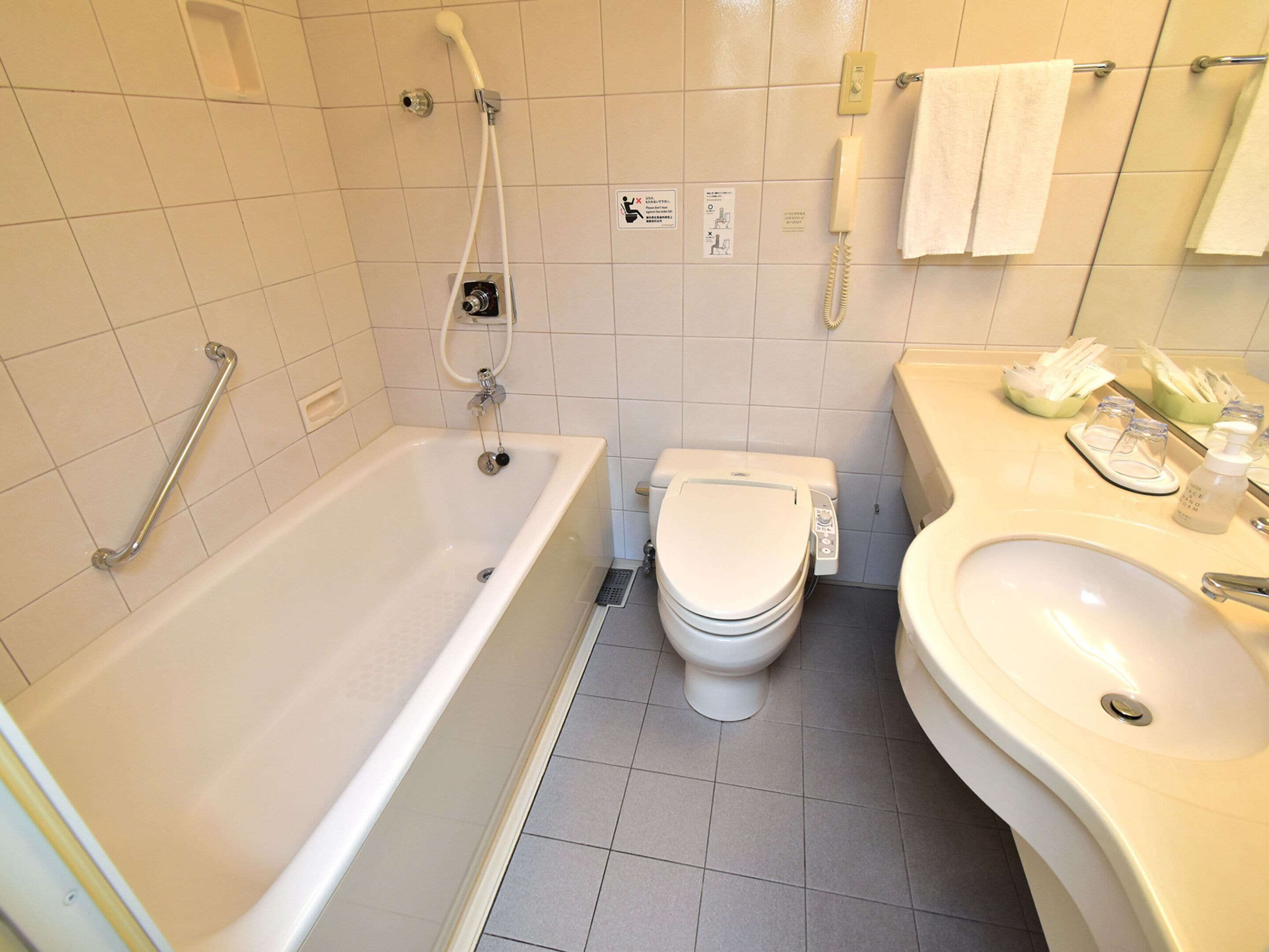 A bathroom with a bathtub, toilet, and sink.