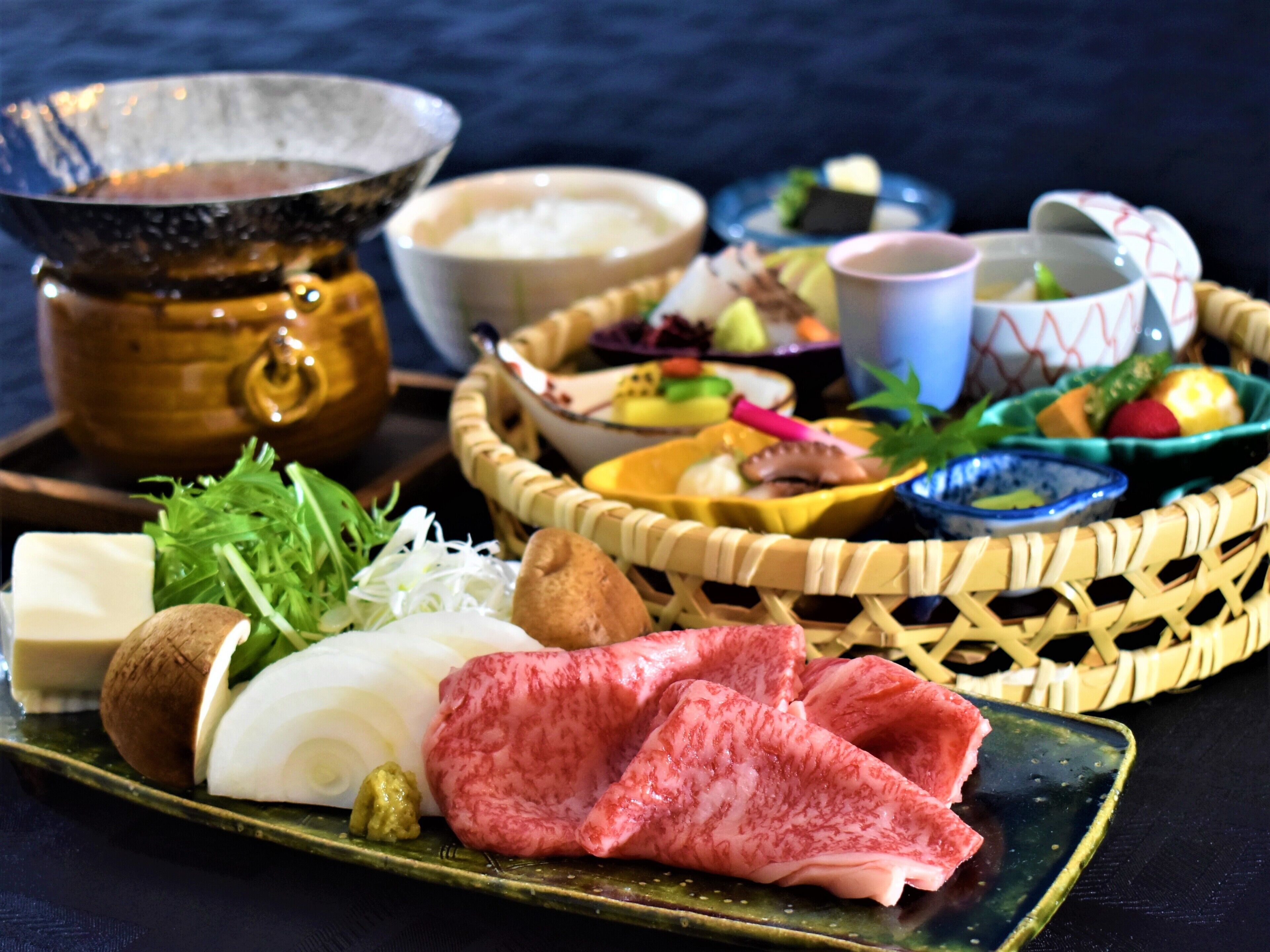 A variety of food items including vegetables, meat, and condiments arranged on a table.