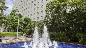 A fountain with water jets in front of a building with a tiled blue mosaic floor. - New Otani Inn Tokyo (Tokyo)