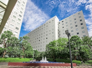 A modern building with a fountain in front.
