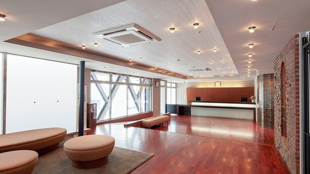 A spacious lobby with a reception desk, seating area, and large windows. - Hotel MyStays Yokohama (Yokohama)