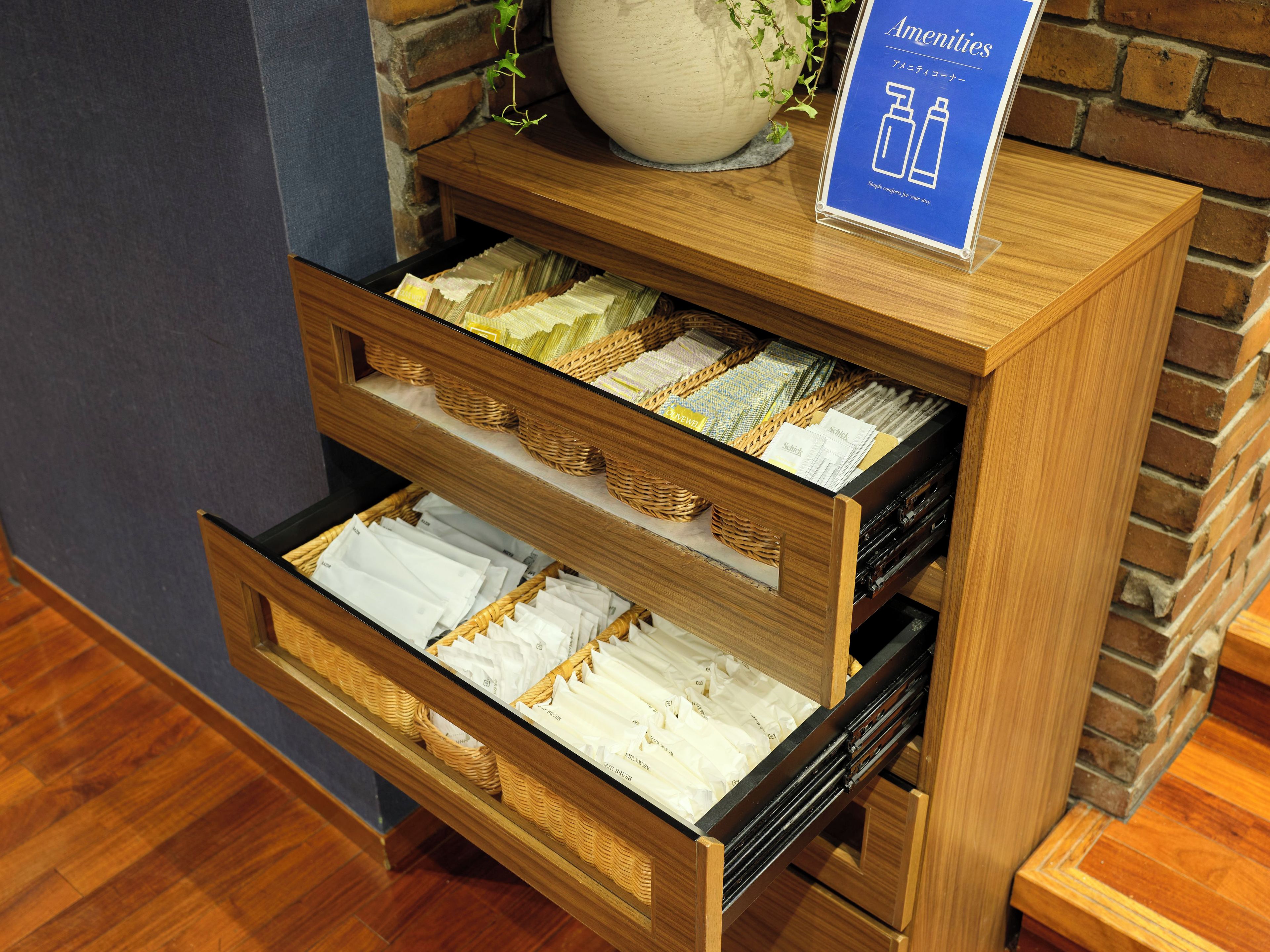 A wooden display case with multiple compartments containing neatly folded towels and linens.