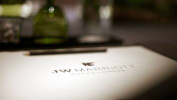 A blurred document with the text "JW MARRIOTT KUALA LUMPUR" on it.