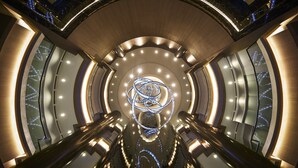 A modern interior with a central spiral staircase, illuminated by recessed lighting and a central light fixture. - JW Marriott Kuala Lumpur (Kuala Lumpur)