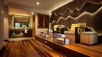 Contemporary space with a seating area, sofa, chairs, and bench, offering a view of lush greenery.