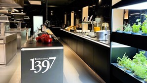 A modern restaurant interior with a counter displaying food items and a sign indicating the restaurant number 1397.