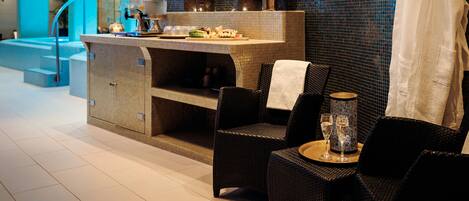 A modern spa area with a reception desk, seating area, and a decorative wall.