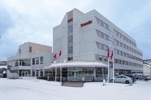 A modern building with a sign reading "Scandic Kirkenes" and a covered entrance. - Scandic Kirkenes (South Varanger)