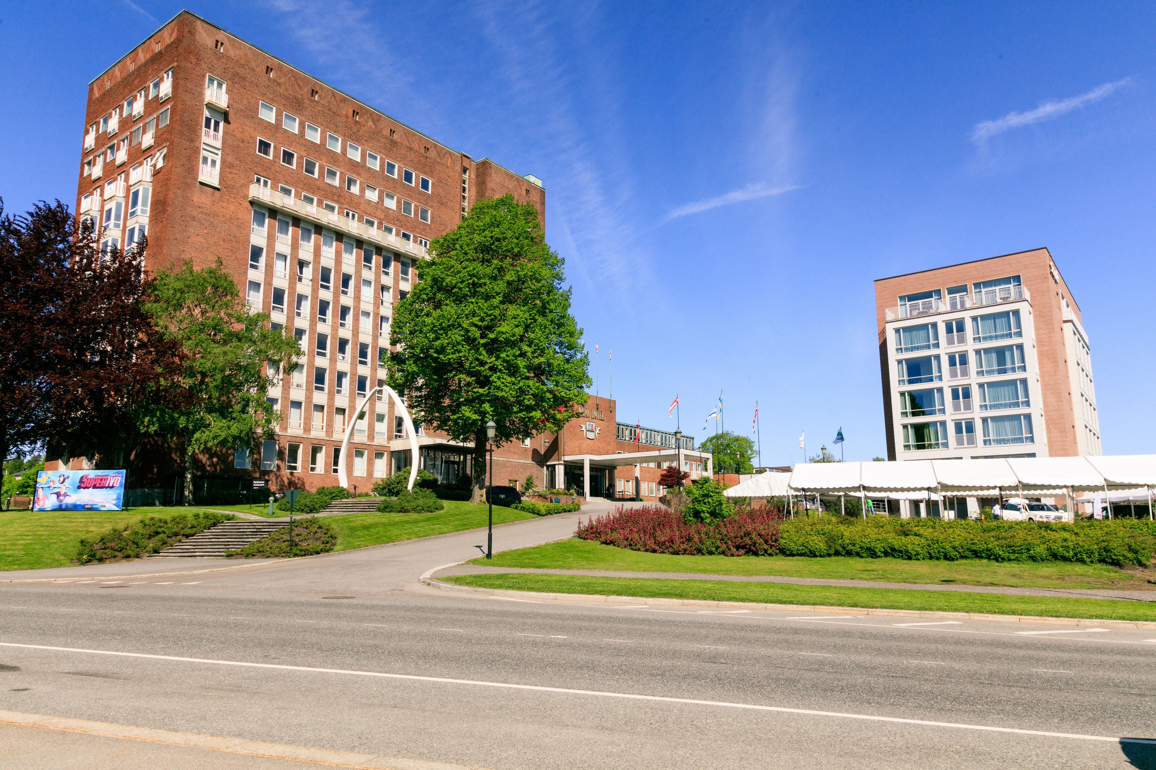 A large brick building with multiple floors and a central entrance.